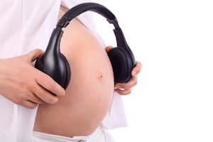 Headphones on pregnant belly