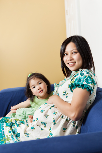 pregnant woman on a sofa with child