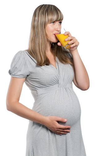 Pregnant woman drinks orange juice