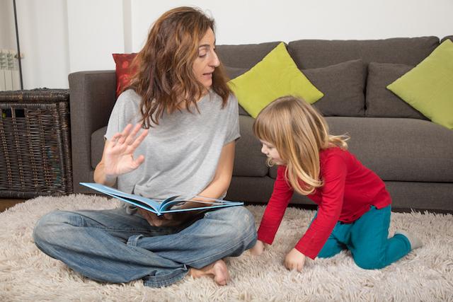 toddler and mother reading