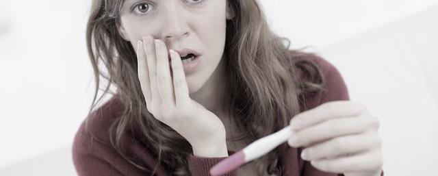 woman surprised pregnancy test