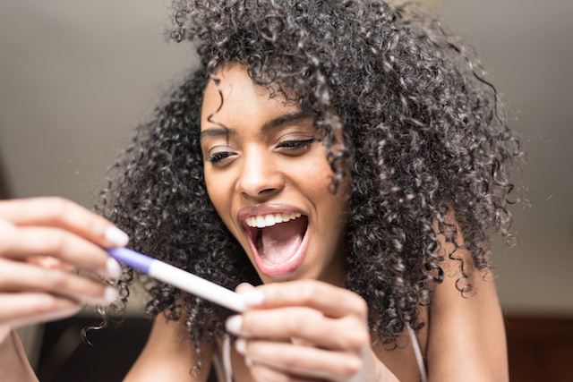 woman happy with positive hcg pregnancy test